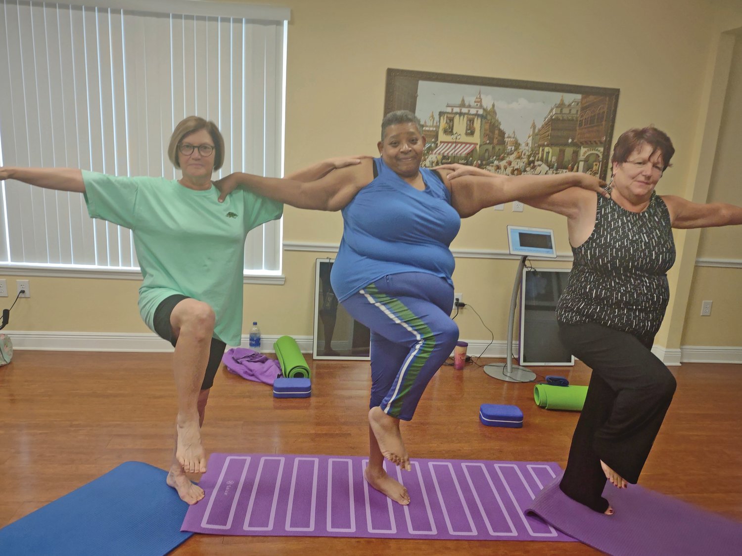 Bette Sayers, Leslie Wade and Cynthia Buckwalter are very determined practioners dedicated to executing the yoga postures to improve balance. To execute this pose with others, the mind must be completely focused to maintain physical support with other students.